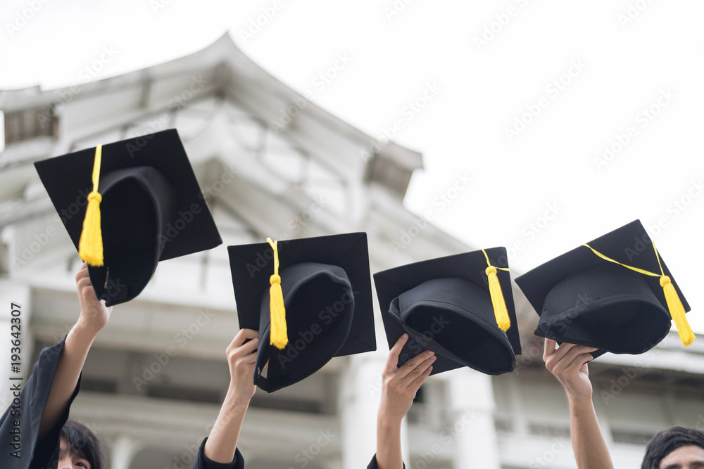 Graduation day.Many hand holding Row of graduation hats on Sky ...