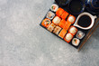 Assorted sushi and tea set served on a black stone slate