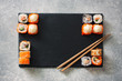 Assorted sushi served on a black stone slate