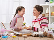 © soleg - Mother and girl baking cookies, home kitchen interior, homemade food concept