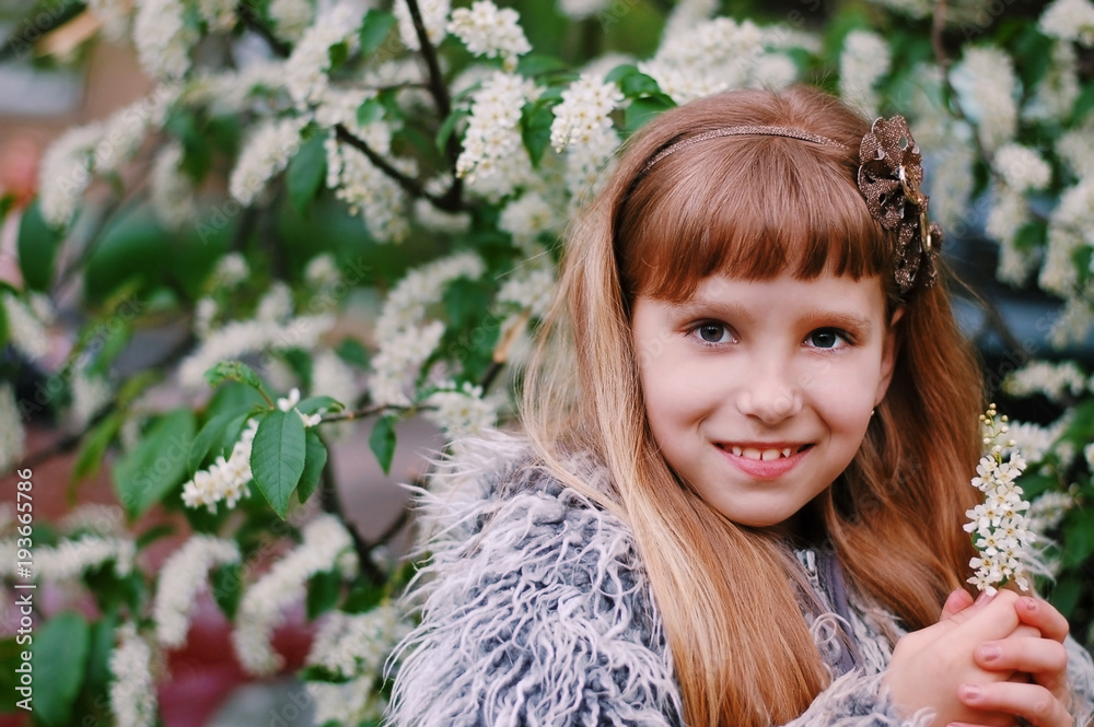 Spring portrait of a young girl with long hair on the background of ...