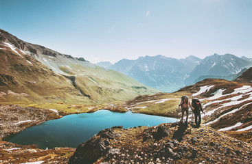 couple backpackers hiking in mountains over lake traveling together lifestyle wanderlust concept adv