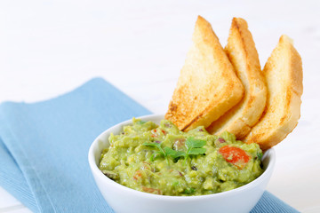 Wall Mural - bowl of guacamole with toast