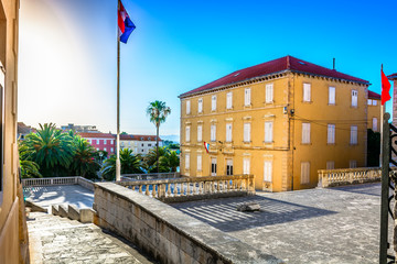 Wall Mural - Brac Supetar town square. / Scenic view at old colorful square in city center of Supetar, popular tourist resort in Croatia, Island Brac.