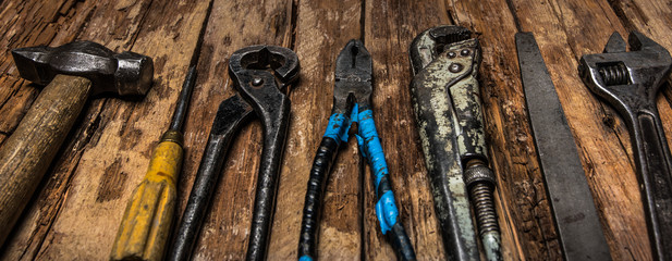 Wooden background with old work tools.