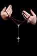 Female Hands Holding Rosary Beads Isolated on Black