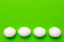 A Number Of White Eggs On A Green Background.