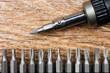 Set of heads for screwdriver (bits) Tools collection copy space, close up, selective focus wooden background