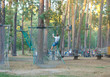 © Natali - cute boy goes on skateboard on the treetops  in adventure rope park. he will cope with all challenges!