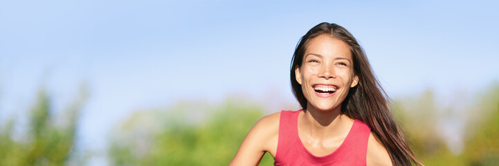 Happy laughing Asian woman with perfect teeth smiling outdoors enjoying sun in summer lifestyle. Beautiful multiracial girl panoramic banner.