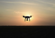 © eleonimages - Quadrocopters silhouette against the background of the sunset