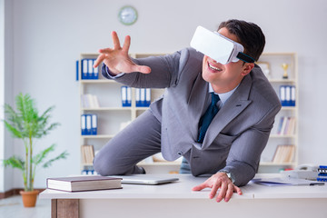 Businessman with virtual reality glasses in modern technology co