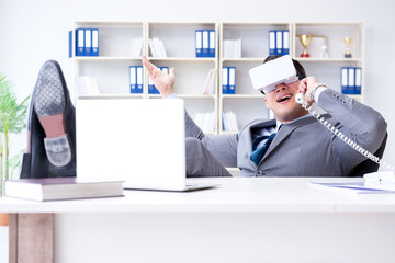 Businessman with virtual reality glasses in modern technology co