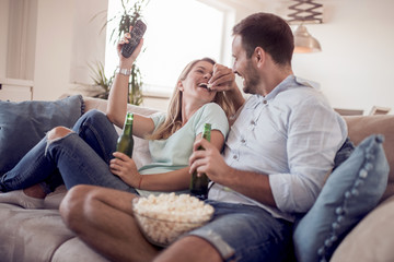 Sticker - Couple watching TV and eating popcorn.