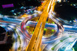 Roundabout intersection city road at night with vehicle light movement