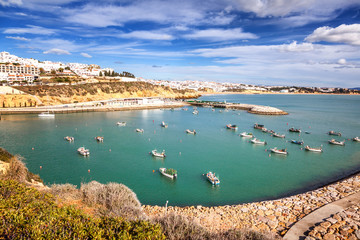 Wall Mural - port with boats and yachts in Albufeira, a city on the Atlantic coast in Portugal, at sunset. Beautiful sea city landscape