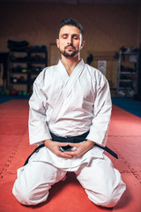 Wall Mural - Martial arts, man in white kimono with black belt