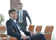 © ASDF - Businessman sitting in an empty conference room