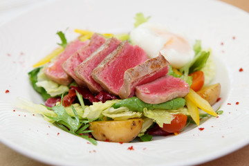 Wall Mural - Nicoise salad of rare fried tuna, potato, salad mix and poached egg