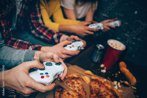 Cuadros en Lienzo Close up of four gaming consoles that all for people getting in their hands