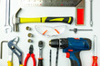 © Goodvibes Photo - Set of construction tools on white background as wrench, hammer, pliers, socket wrench, spanner, tape measure, electric drill,safety glasses, screwdriver