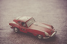 Old Rusty Red Tin Toy Car On Purple Background. Fire Chief. Childhood Object, Nostalgia And Vintage.