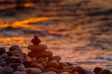 Fototapeta Londyn - stack of zen stones on pebble beach