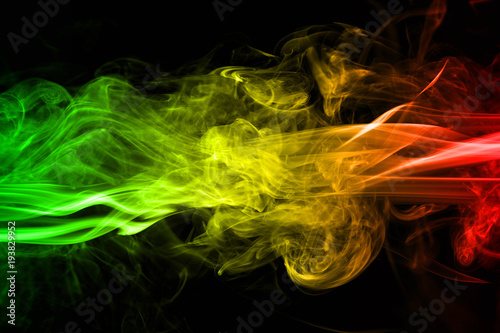 Fotografía abstract background smoke curves and wave reggae colors green, yellow, red color
