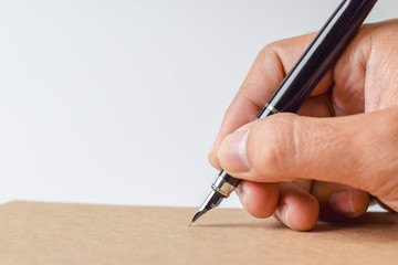 Poster - Human hand signing on formal paper at the table on white background