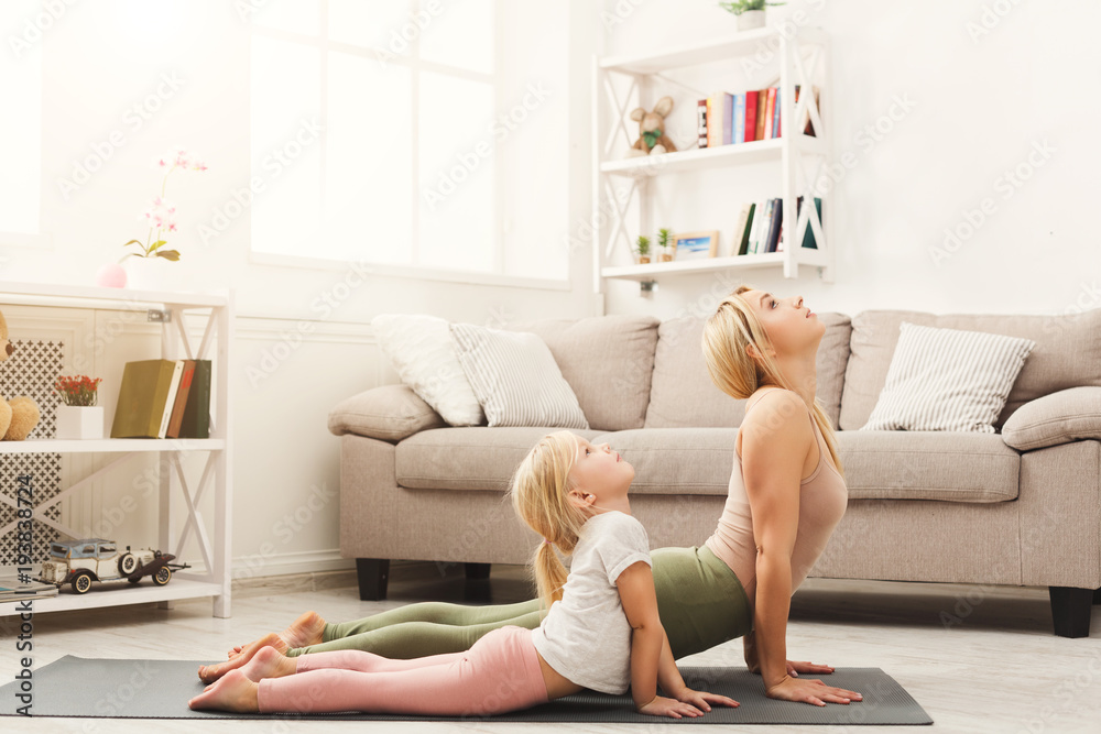 Mother and daughter doing yoga exercises at home Stock Photo | Adobe Stock