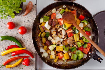 Mix of fresh vegetables fried in the rustic pan, fresh hot chili peppers, tomato and herbs.