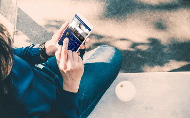 Poster - Woman sitting and use smart home control app on mobile phone and drink take away coffee outside house,Automation technology.