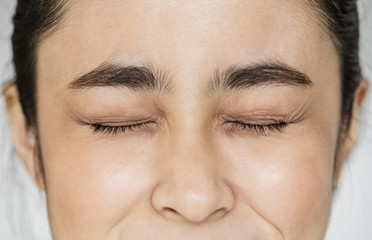 Canvas Print - Closeup of Young Asian girl portrait eyes closed