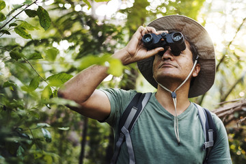 Wall Mural - Man using binoculars