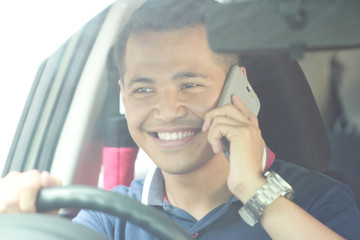 Wall Mural - man using mobile phone while driving his car