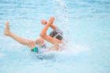 Fototapeta  - Boy getting splashed in a waterpark