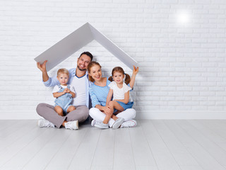 Canvas Print - concept housing a young family. mother father and children in  new home.