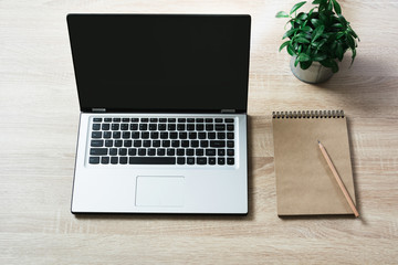 Wall Mural - Open laptop on office wooden desk table. Top view, copy space.