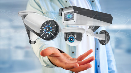 Poster - Businessman holding a Security camera system and network connection - 3d rendering