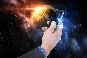 Wall Mural - hand holding smartphone over planet in space