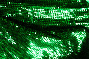 Wall Mural -  Background texture, pattern. The fabric is dark green with sequins. Make a statement with sequins ! Presenting the stylish Two-toned Paillette Sequins on the nylon spandex stretch backing.