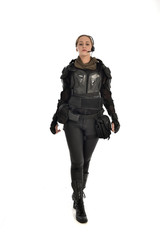 Poster - full length portrait of female  soldier wearing black  tactical armour, isolated on white studio background.