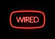 Wired neon sign on brick wall background.