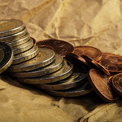 Coins of euro cents and two euros lie on the background of coins.