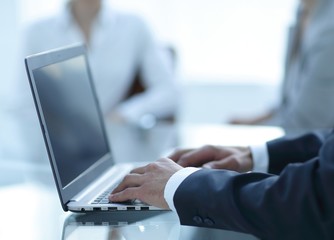 closeup of businessman typing on laptop.