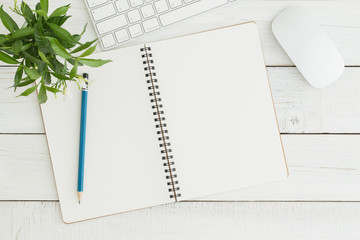 Wall Mural - empty open notebook on white wood table top view,flat lay photo of office desk with mouse and keyboa