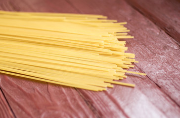 Spaghetti - yellow pasta, ready for cooking. Isolated on white background.