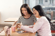 © Viacheslav Yakobchuk - Great mood. Happy joyful nice women sitting together and looking at the photos while having fun