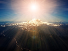 Heavenly Rays Of Sunlight Above Mountain Peak