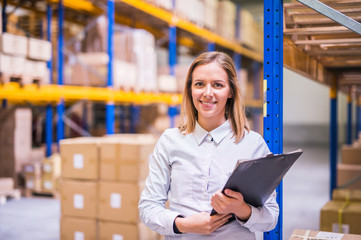 Wall Mural - Portrait of a woman warehouse worker or supervisor.